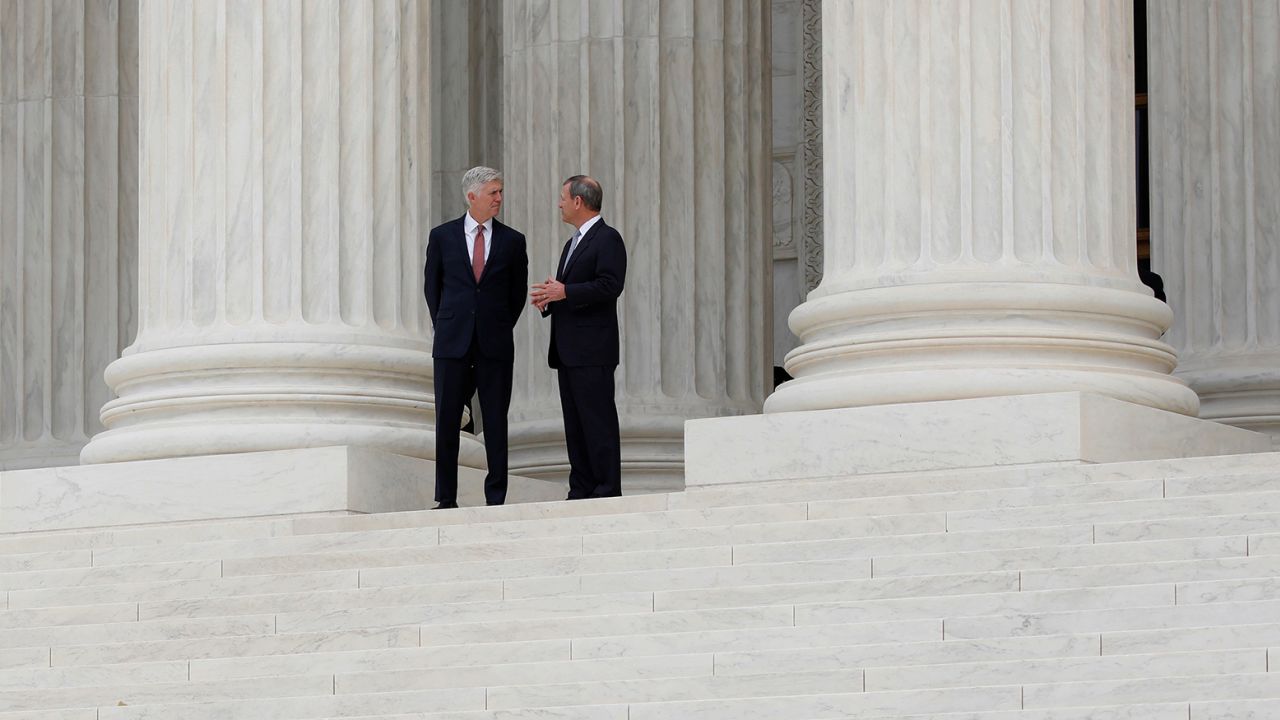 In this 2017 photo, Chief Justice John Roberts, right,  and Justice Neil Gorsuch appear outside the Supreme Court in Washington, DC.