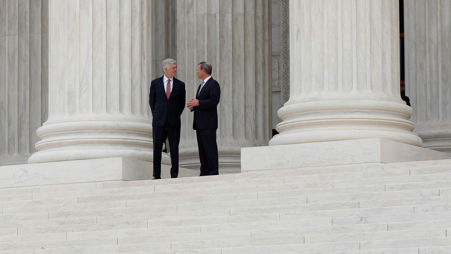 In this 2017 photo, Chief Justice John Roberts, right,  and Justice Neil Gorsuch appear outside the Supreme Court in Washington, DC.