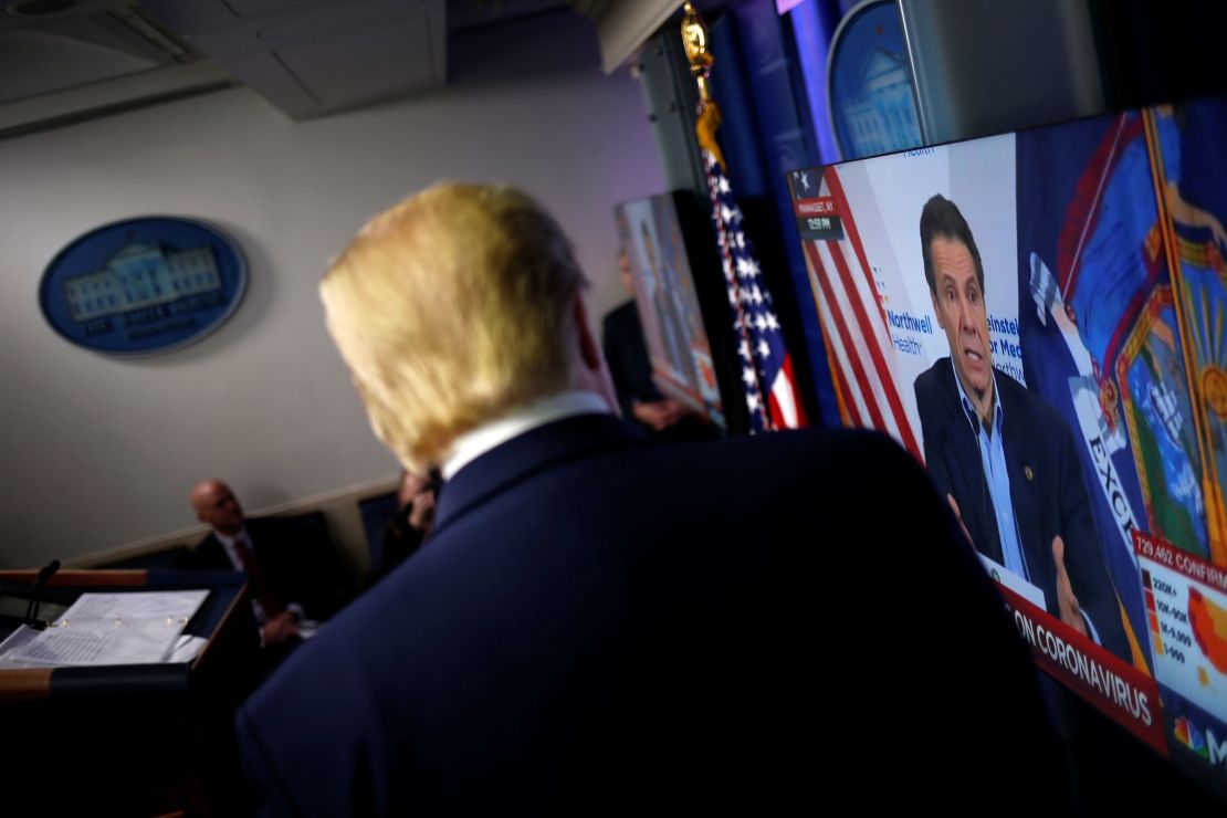President Donald Trump watches a clip from MSNBC of New York governor Andrew Cuomo speaking at Cuomo's daily briefing, during the daily Covid-19 task force briefing at the White House in Washington, DC, on April 19, 2020.