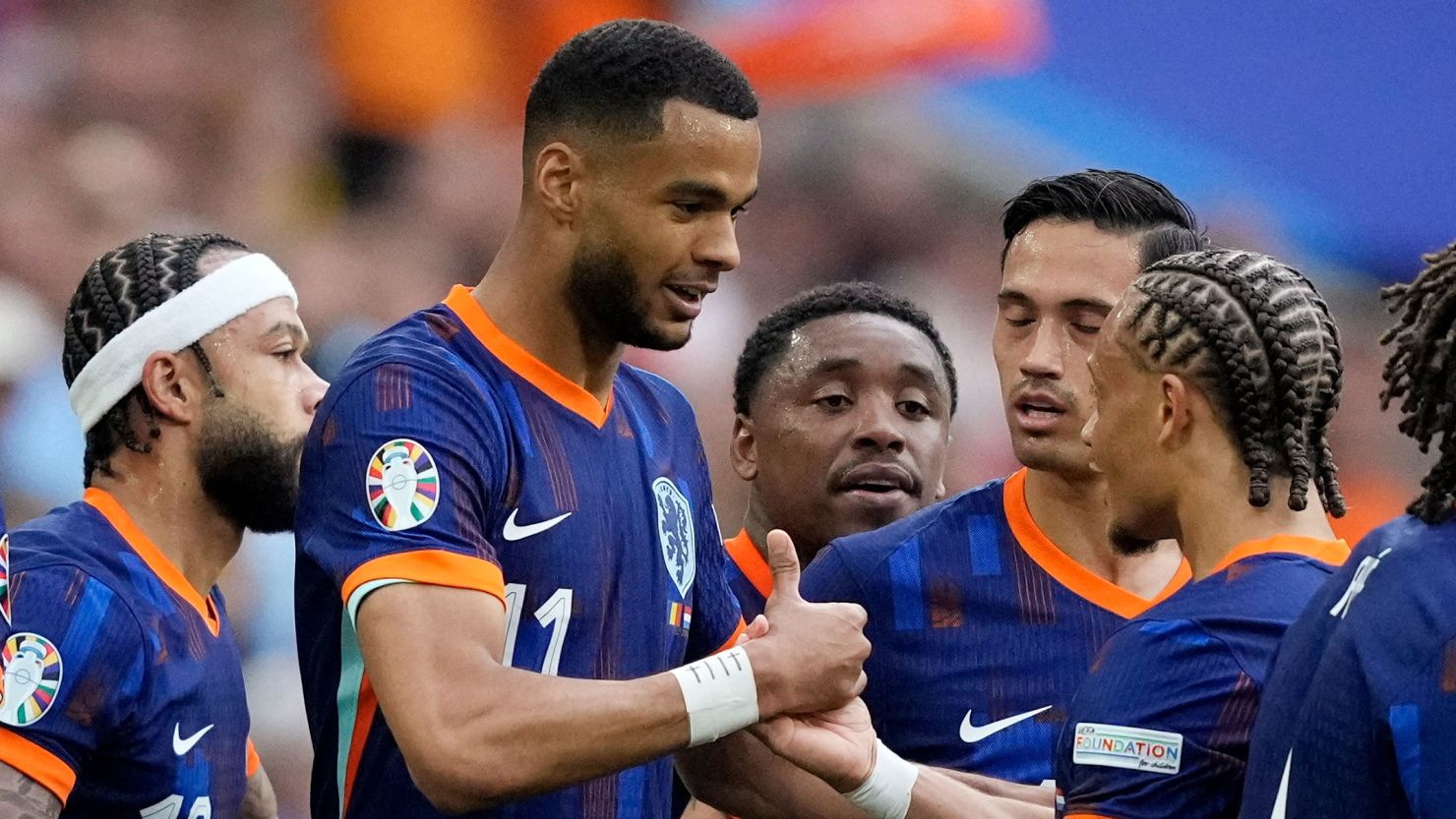 Cody Gakpo celebrates with his teammates after scoring the Netherlands' first goal against Romania.