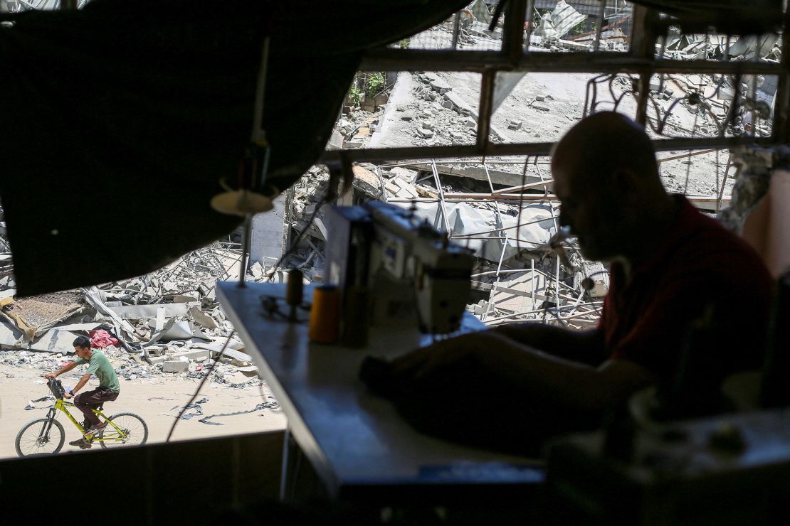 A Palestinian tailor works in a newly reopened sewing factory after the machines were retrieved from a building hit in an Israeli strike, amid Israel-Hamas conflict, in Khan Younis in the southern Gaza Strip July 3, 2024. 