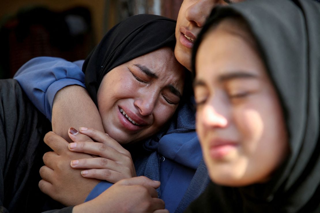 Relatives of a Palestinian killed in an Israeli strike react at the site of the strike, near a school sheltering displaced people, amid the Israel-Hamas conflict, in Khan Younis in the southern Gaza Strip July 10, 2024. 