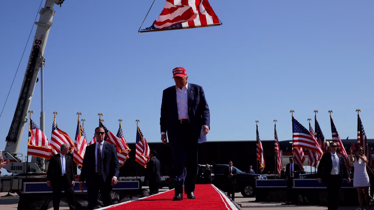 Former President Donald Trump walks under a US flag as he holds a campaign rally in Wilmington, North Carolina, on September 21. 