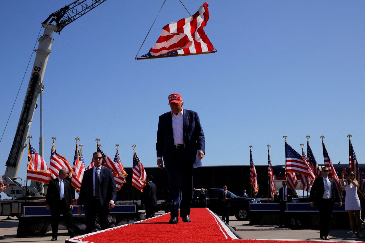 Former President Donald Trump walks under a US flag as he holds a campaign rally in Wilmington, North Carolina, on September 21. 