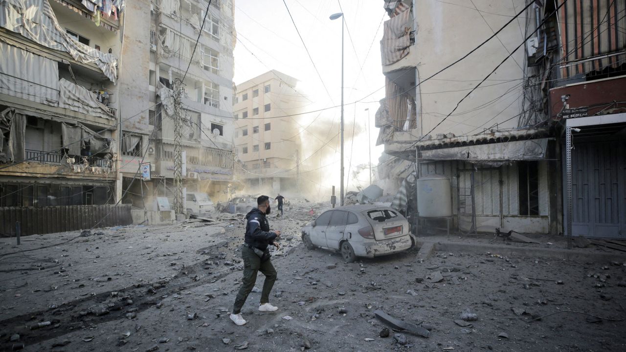 Men run for cover after an Israeli strike on the Mreijeh neighbourhood in Beirut's southern suburbs amid cross-border hostilities between Hezbollah and Israel in Beirut, Lebanon, on October 4.