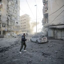 Men run for cover after an Israeli strike on the Mreijeh neighbourhood in Beirut's southern suburbs amid cross-border hostilities between Hezbollah and Israel in Beirut, Lebanon, on October 4.