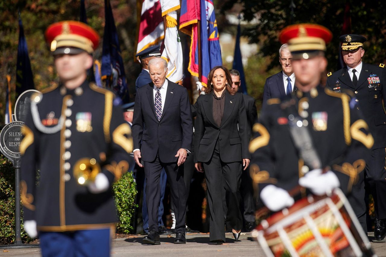 President Joe Biden and Vice President Kamala Harris walks to attend a wreath laying ceremony at the Tomb of the Unknown Soldier in Arlington National Cemetery on Veterans Day in Arlington, Virginia, on November 11. 