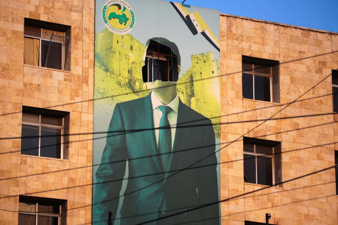 A view shows a damaged poster of Syria's President Bashar al-Assad in Aleppo after the Syrian army said that dozens of its soldiers had been killed in a major attack by rebels who swept into the city on November 30. 