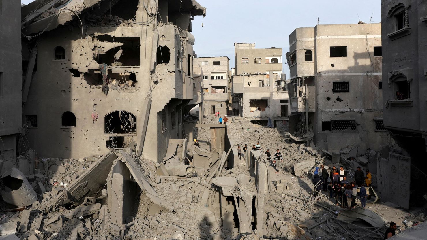 Palestinians inspect damage at the site of an Israeli strike on a house at the Nuseirat refugee camp in the central Gaza Strip on December 7. 