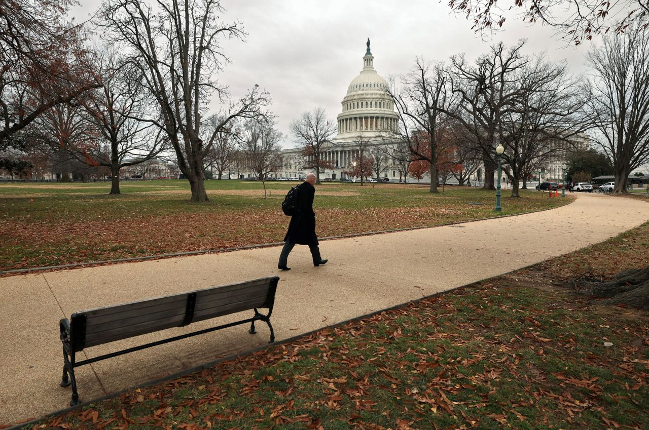 A man walks toward the Capitol on a day where a potential government shutdown looms during the holidays after a spending bill backed by Donald Trump failed in the US House of Representatives, on Capitol Hill in Washington, DC, on December 20.