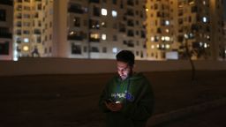 In this December 2024 photo, an Iranian man looks at his mobile phone in Tehran.