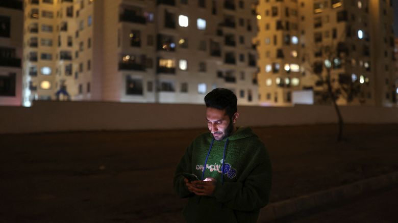 In this December 2024 photo, an Iranian man looks at his mobile phone in Tehran.