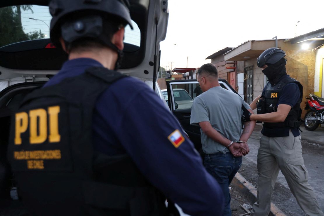 Members of Chile’s Investigative Police detain a man suspected of being a member of the Venezuelan gang Tren de Aragua in Santiago, Chile, in this undated handout photo released on January 22, 2025.