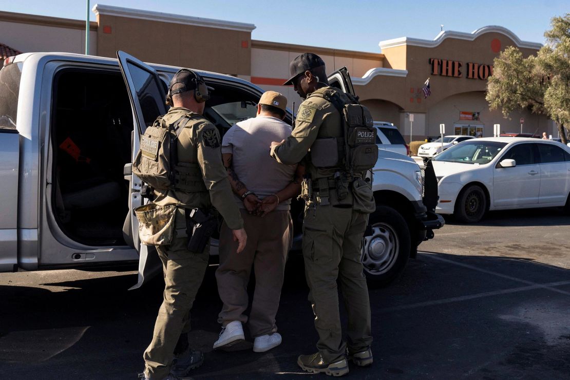 An immigrant is detained by US Immigrations and Customs Homeland Security Investigations agents at a Home Depot parking lot in Tucson, Arizona, on January 26.