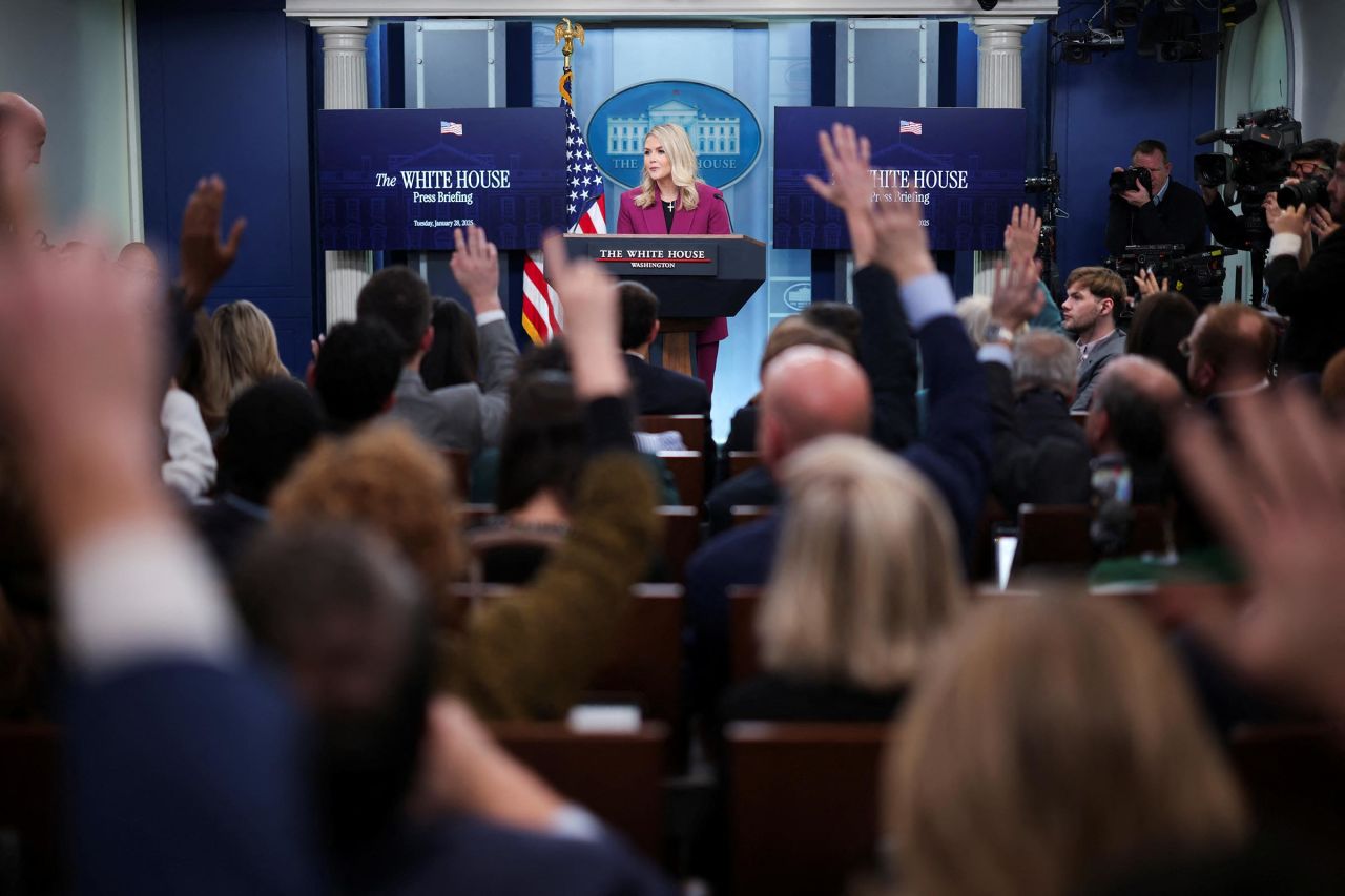 Members of the media raise their hands as White House Press Secretary Karoline Leavitt delivers remarks during her first daily briefing, at the White House, in Washington, DC, on January 28, 2025. 