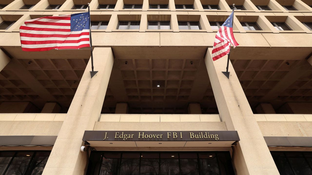 Flags fly over an entrance to FBI headquarters, days after the Trump administration launched a sweeping round of cuts at the Justice Department, in Washington, DC, on February 3. 