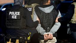 In this February 5 photo, Immigration and Customs Enforcement agents detain a man after conducting a raid at the Cedar Run apartment complex in Denver, Colorado.