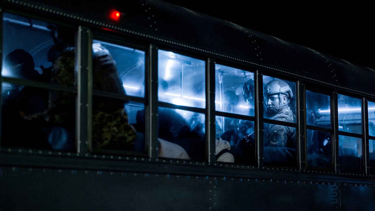Salvadoran police officers escort alleged members of the Venezuelan gang Tren de Aragua recently deported by the US government to be imprisoned in the Terrorism Confinement Center (CECOT) prison, as part of an agreement with the Salvadoran government, in Tecoluca, El Salvador, in this handout image obtained March 16.