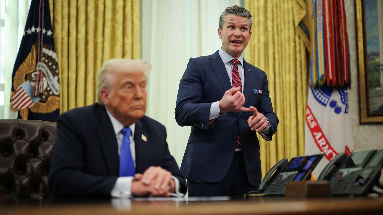 Defense Secretary Pete Hegseth speaks next to President Donald Trump in the Oval Office at the White House in Washington, DC, on Friday, March 21. 