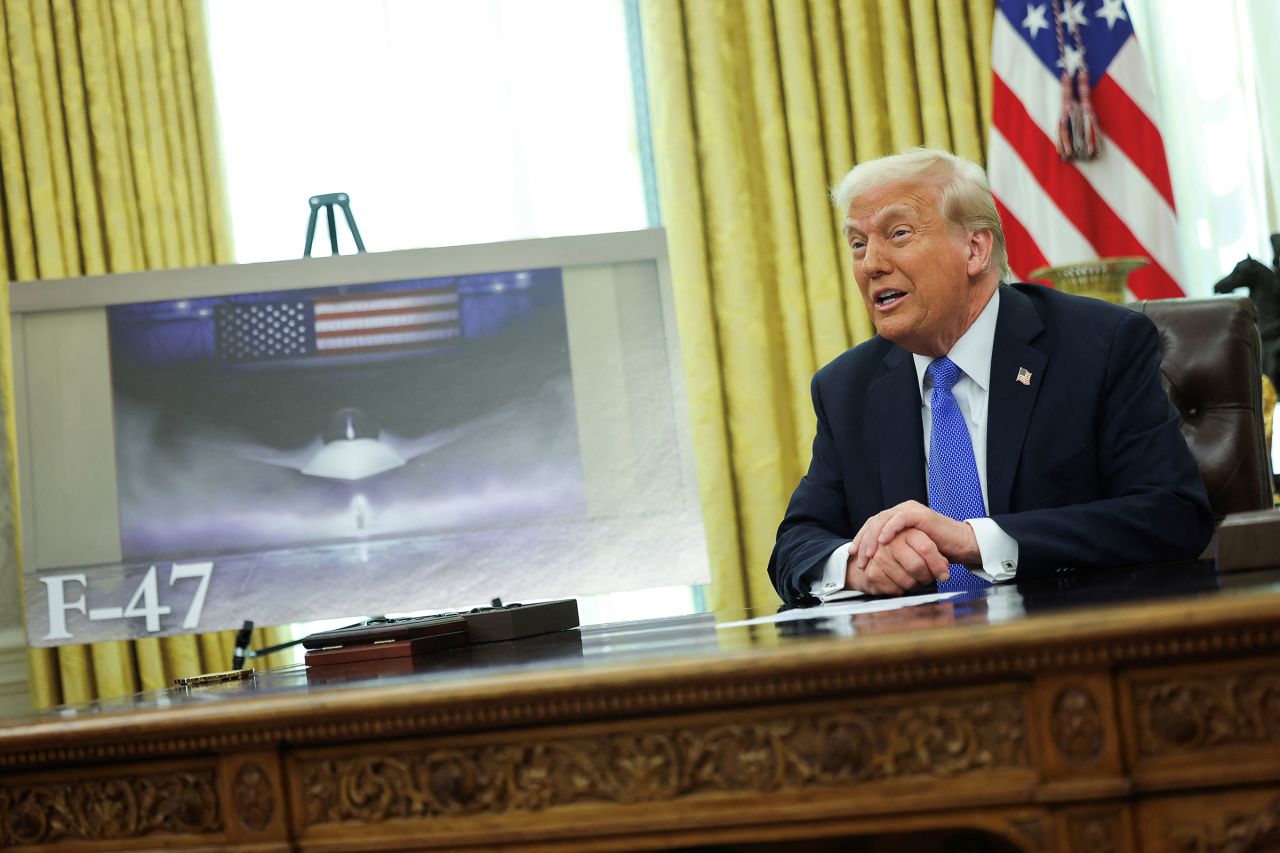 President Donald Trump delivers remarks as an image of an F-47 sixth-generation fighter jet is displayed in the Oval Office at the White House in Washington, DC, on March 21, 2025.