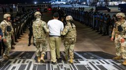 This handout photo from Press Secretary of the President of El Salvador show US military personnel escorting an alleged gang member to El Salvador's Cecot prison at the El Salvador International Airport in San Luis Talpa, El Salvador, on April 12. 