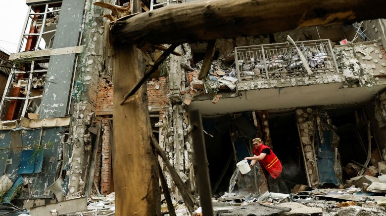 A municipality worker cleans an apartment building that was damaged in a Russian drone strike in Kyiv, Ukraine, on May 25.