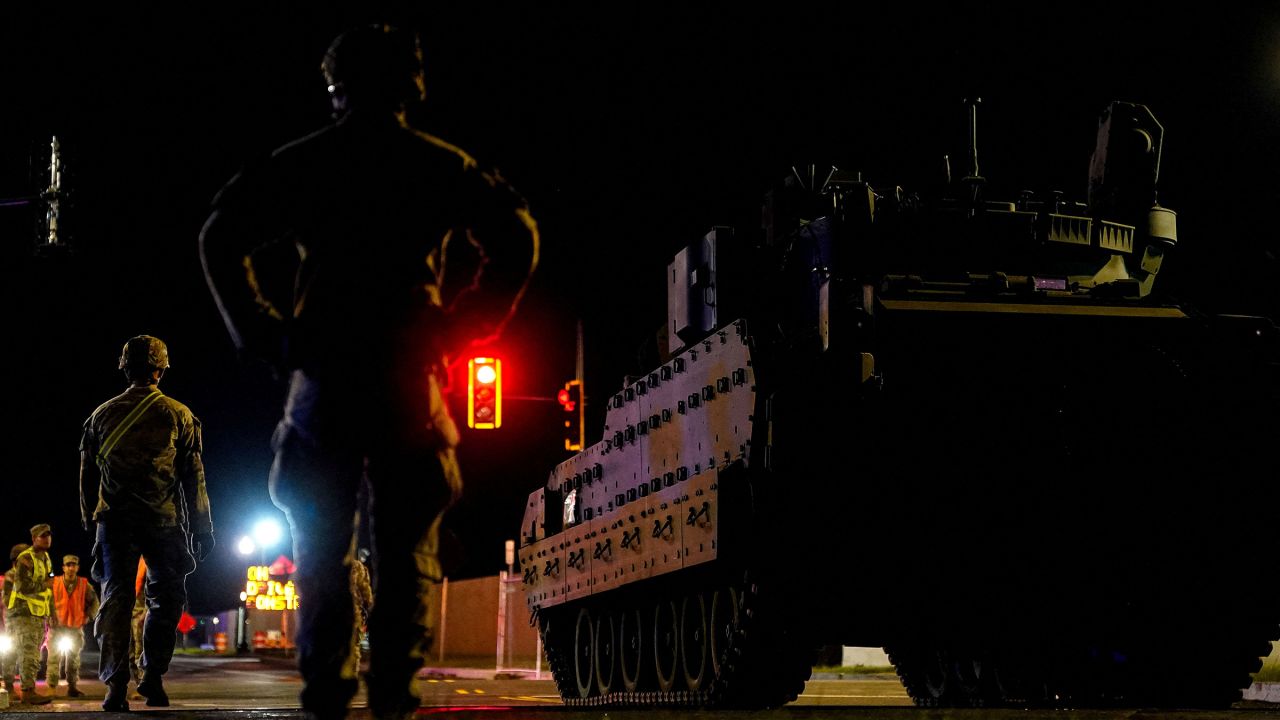 Military personnel stand near military vehicle to be used in the US Army's 250th Birthday celebration and Parade in Washington, DC, on June 10.