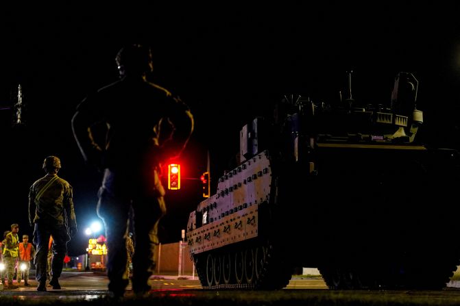 Military personnel stand near military vehicle to be used in the US Army's 250th Birthday celebration and Parade in Washington, DC, on June 10.