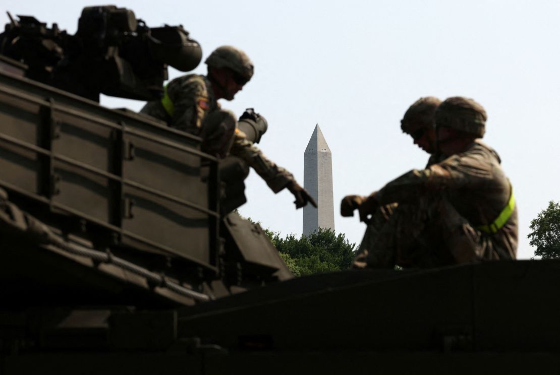 The Washington Monument is seen in the background as soldiers work on an M1A2/Abrams tank ahead of the upcoming US Army 250th anniversary celebration parade in Washington, DC, on June 11.