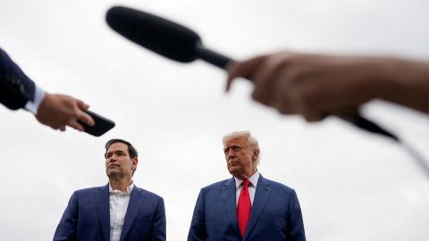 President Donald Trump stands next to Secretary of State Marco Rubio as he prepares to depart for Hagerstown, Maryland, at Morristown Municipal Airport in Morristown, New Jersey, on June 8.