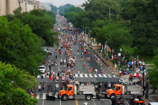 People line up on Constitution Avenue to go through a security checkpoint to attend the military parade commemorating the U.S. Army's 250th birthday in Washington, DC, on June 14. 