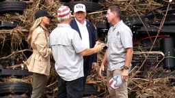 President Donald Trump and first lady Melania Trump speak with first responders as they visit a scene of devastation along the banks of the Guadalupe River after catastrophic floods in Kerr County, Texas, on July 11.