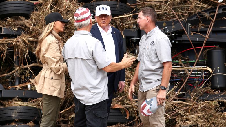 President Donald Trump and first lady Melania Trump speak with first responders as they visit a scene of devastation along the banks of the Guadalupe River after catastrophic floods in Kerr County, Texas, on July 11.