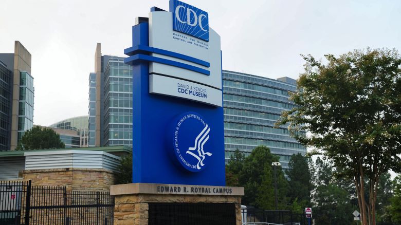 The logo of Center of Disease Control and Prevention (CDC) is seen as the glass of it's building in the background is pockmarked by bullet holes, following a deadly shooting incident in Atlanta, Georgia, on August 9, 2025.
