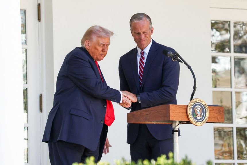 President Donald Trump shakes hands with Senate Majority Leader John Thune during a Rose Garden Club lunch at the White House in Washington, DC, October 21, 2025.