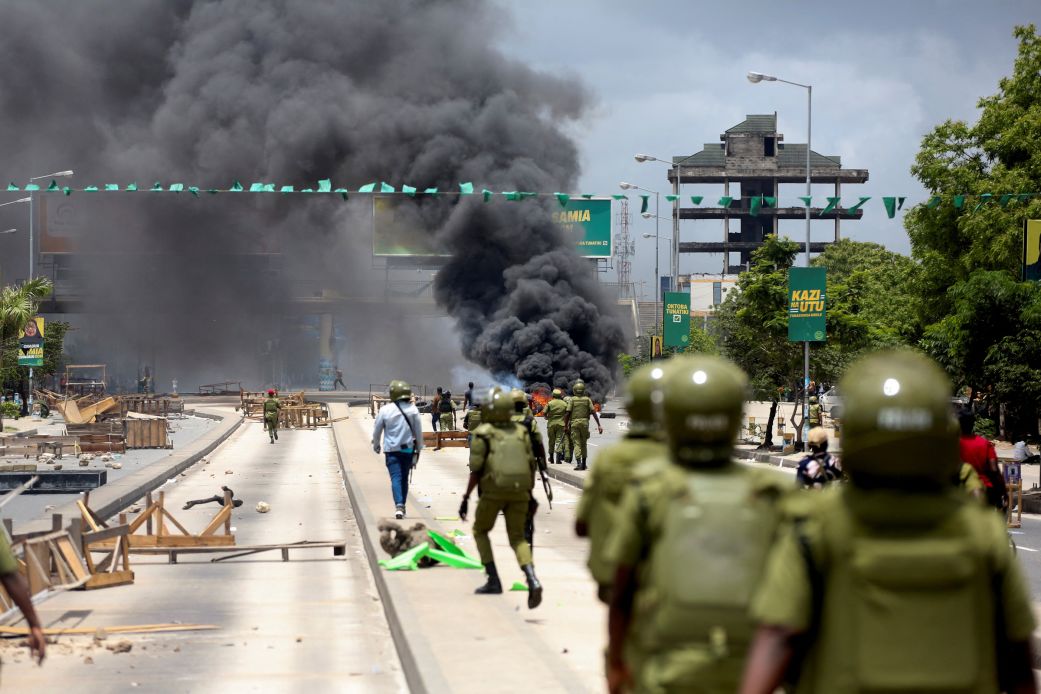 Riot police disperse demonstrators during violent protests in Dar es Salaam, Tanzania, on Wednesday, after the two leading opposition candidates were disqualified from the presidential election.