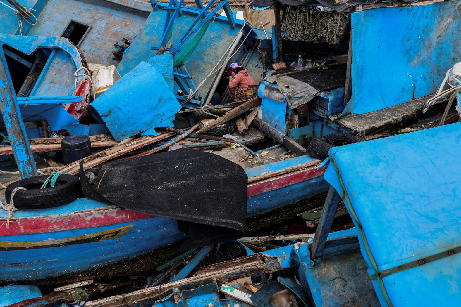 A woman in Vietnam’s Xuan Cau District sits amid fishing vessels that were piled up on land after Typhoon Kalmaegi on Saturday, November 8. Kalmaegi, <a href="index.php?page=&url=https%3A%2F%2Fwww.cnn.com%2F2025%2F11%2F06%2Fasia%2Ftyphoon-kalmaegi-philippines-damage-vietnam-intl-hnk">one of the strongest typhoons on record to hit Vietnam</a>, brought torrential rains and destructive winds to an area already saturated by floods due to record rainfall.
