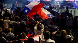 A supporter of Jose Antonio Kast, presidential candidate of the far-right Republican Party, holds Chilean flags as they attend one of Kast's last closing campaign rallies, ahead of the November 16 presidential election, in Santiago, Chile November 11, 2025.