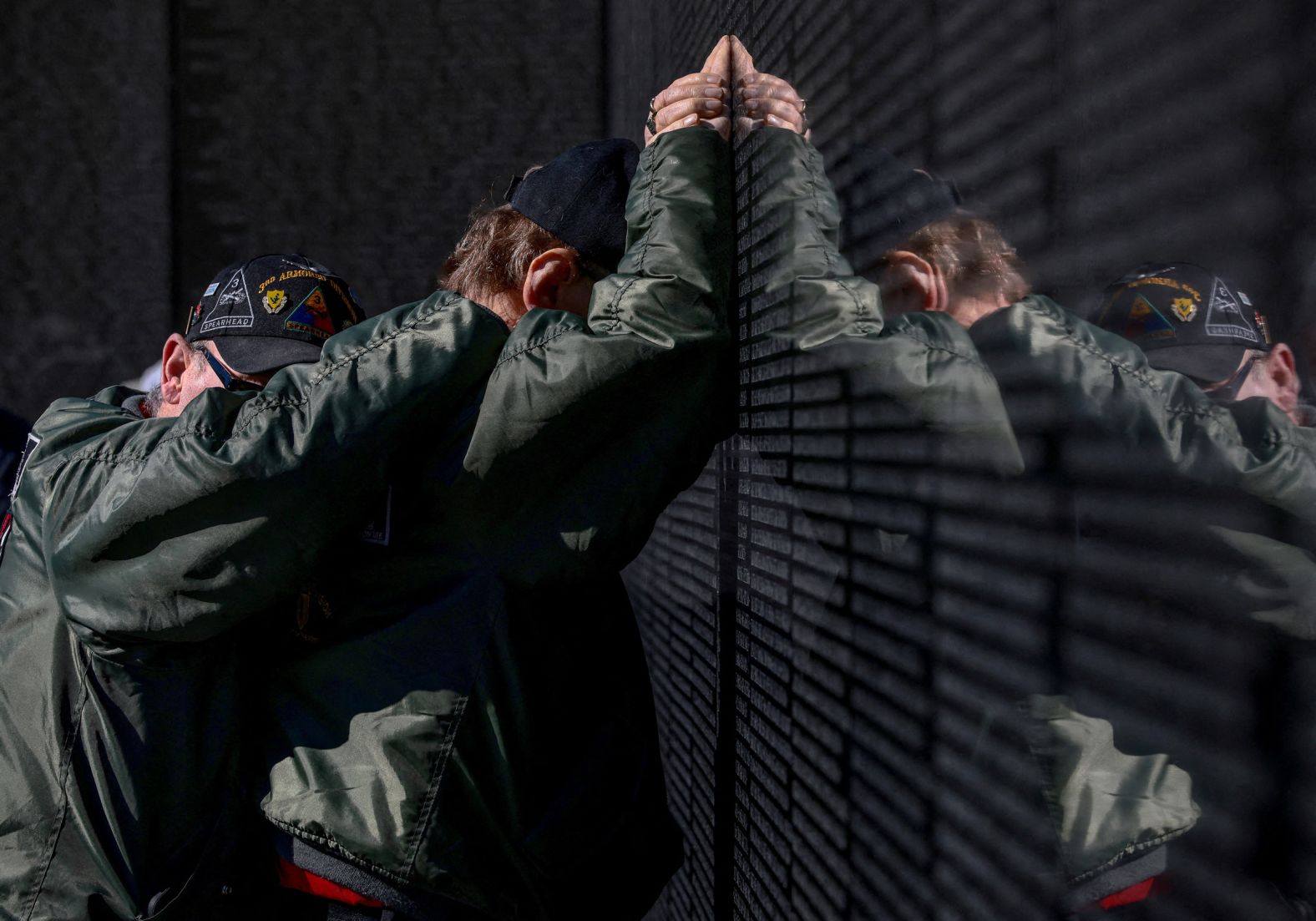 Ray Nahrgang hugs Vietnam War veteran Harry Metzler as Metzler touches his friends’ names at the Vietnam Veterans Memorial in Washington, DC, on Tuesday, November 11. It was Veterans Day in the United States.