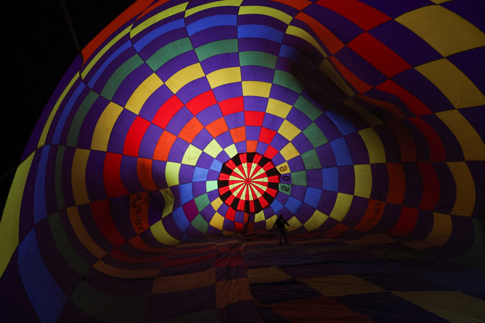 A pilot prepares his hot air balloon before flying over León, Mexico, during the International Hot Air Balloon Festival on Monday, November 17.