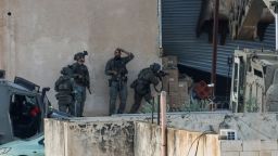 Israeli soldiers take position during a raid in Jenin in the Israeli-occupied West Bank, November 27, 2025.