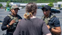 This photo provided by the US Marshals Service shows two US marshals speaking with an individual during Operation We Will Find You 2, a six-week nationwide missing child operation.