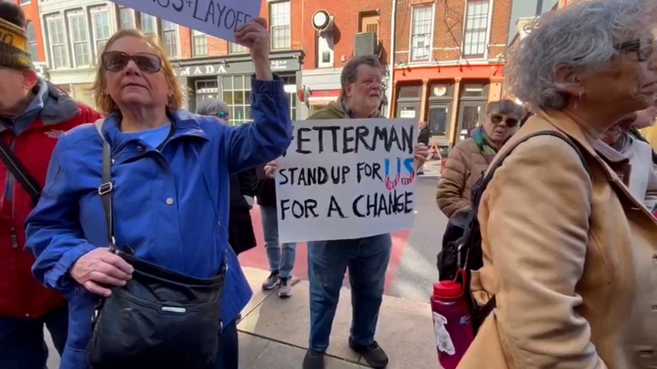 People protest near Sen. John Fetterman’s Philadelphia field office to Independence National Historic Park.