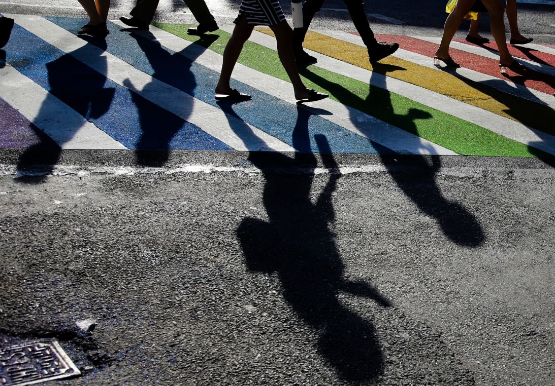 Pedestrians cross the intersection of Christopher Street and Seventh Avenue near the Stonewall Inn on June 27, 2019, in New York.