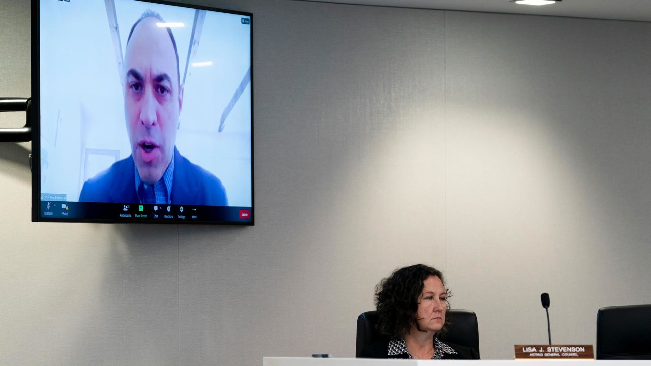 In this August 2023 photo, Commissioner Allen Dickerson appears on a screen while speaking during a Federal Election Commission public meeting in Washington, DC.