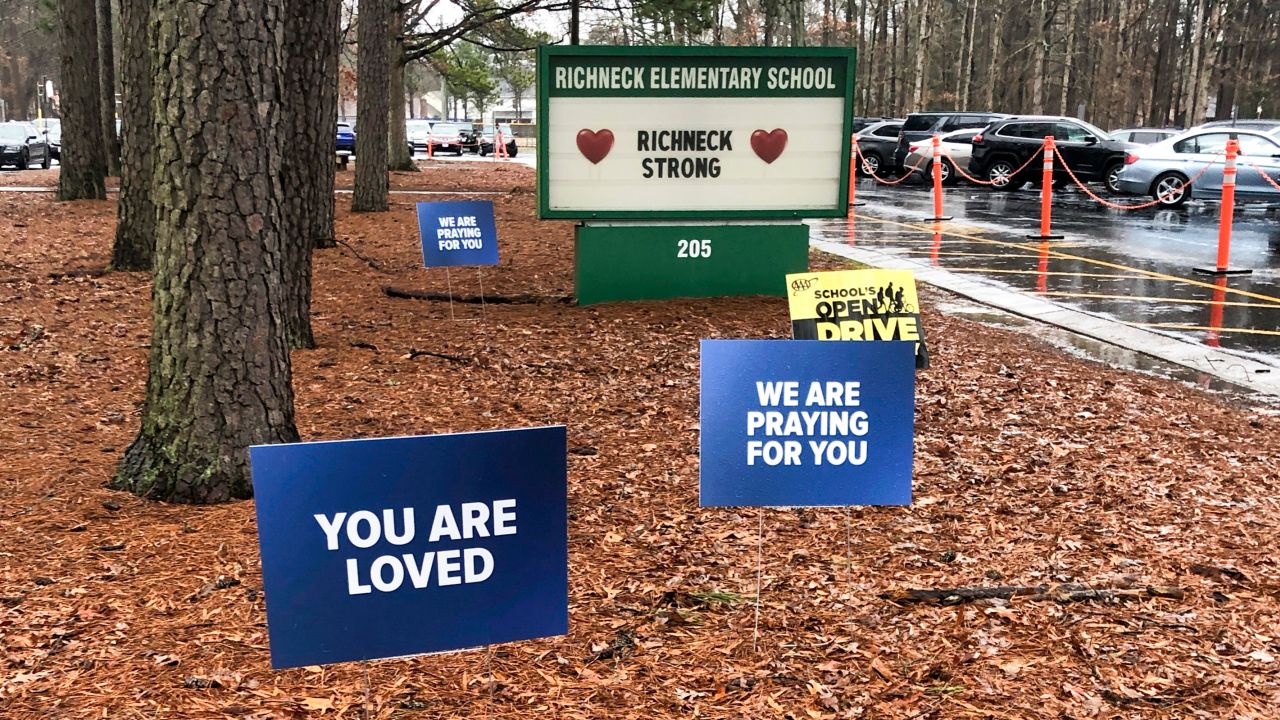 In this January 2023 photo, signs stand outside Richneck Elementary School in Newport News, Virginia.