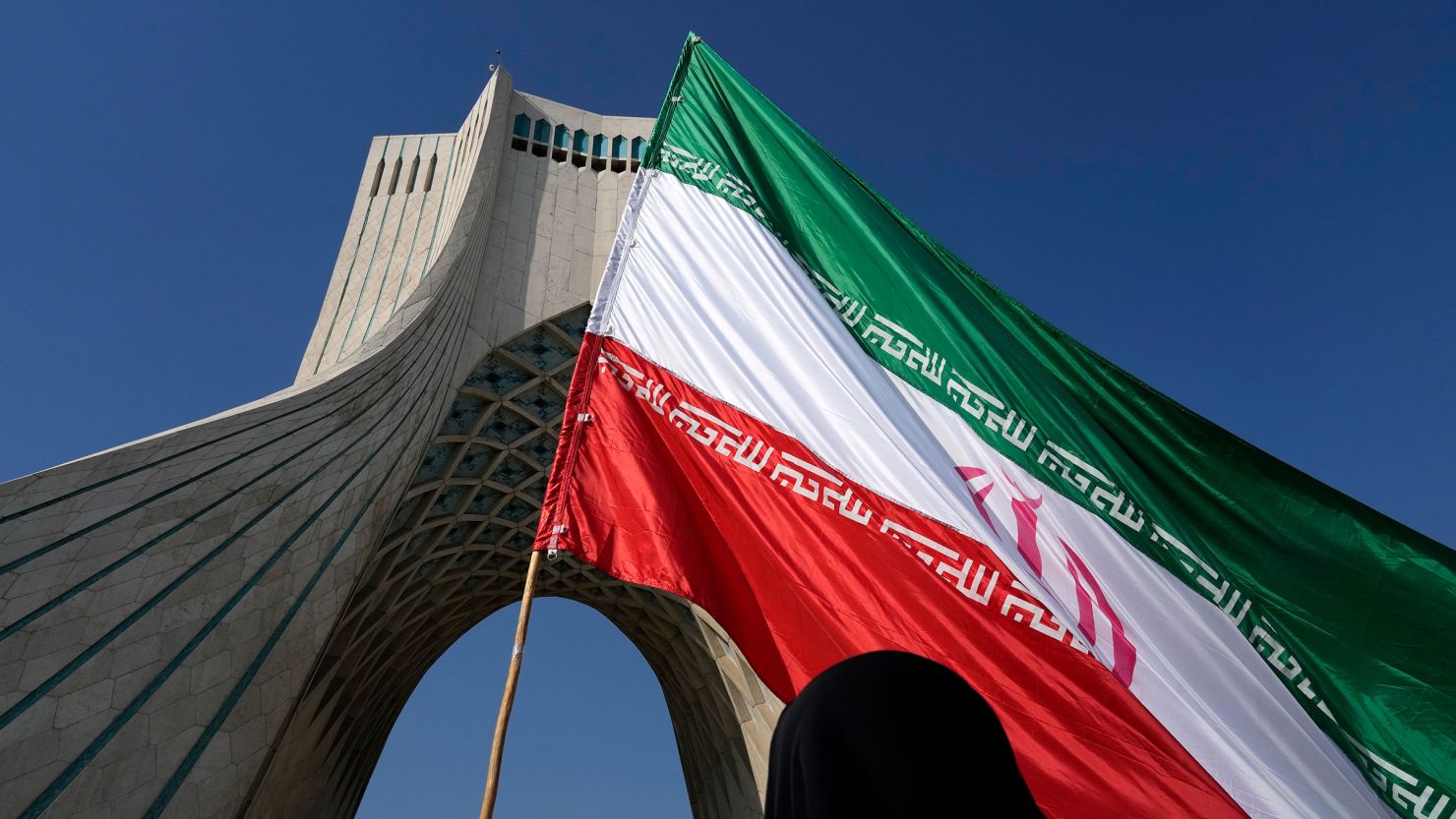 An Iranian flag is carried under the Azadi (Freedom) monument tower during the annual rally commemorating Iran's 1979 Islamic Revolution in Tehran in February.