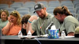 James Herling pauses his testimony while recalling the moment he realized the shooter was his brother-in-law, Robert Card, while testifying, Thursday, May 16, 2024, in Augusta, Maine, during a hearing of the independent commission investigating the law enforcement response to the mass shooting in Lewiston, Maine. Nicole Herling, sister of the shooter, cries on her husband's shoulder. (AP Photo/Robert F. Bukaty)