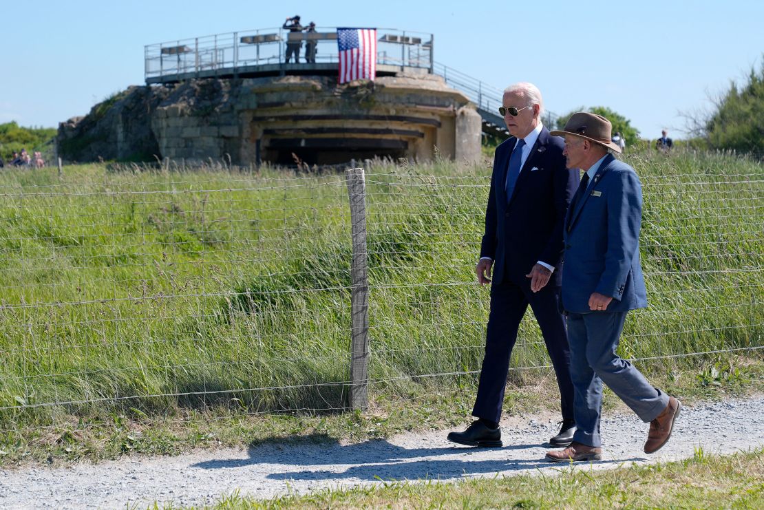 President Joe Biden walks with Scott Desjardins, superintendent of Normandy American Cemetery and Pointe du Hoc, before delivering remarks on the legacy of Pointe du Hoc, and democracy around the world on Friday, June 7, in Normandy, France.