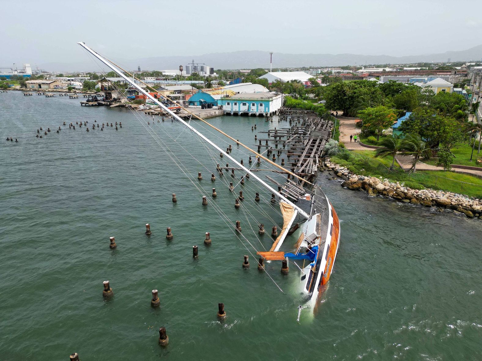 A boat damaged by Hurricane Beryl lies on its side at a dock in Kingston on Thursday.